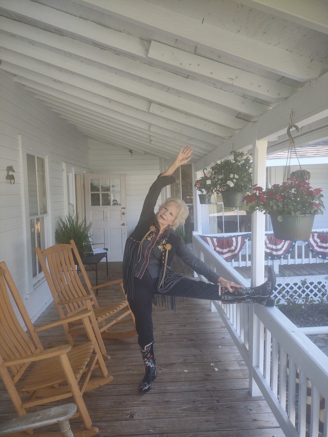 Nancy Dale took her yoga mat to practice postures on the porch dressed in cowboy boots and vest to do yoga and to tell the true stories written in her books of the Florida pioneer “Cow Hunters.”